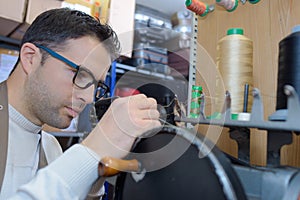 Young shoe maker working in workshop