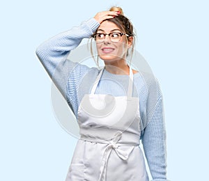 Young shop owner woman wearing apron