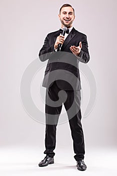 Young Showman presenter with microphone against white background.