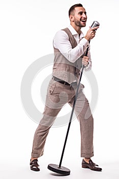 Young showman in suit singing with emotions gesture over the microphone with energy