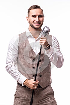 Young showman in suit singing with emotions and pointed gesture over the microphone with energy