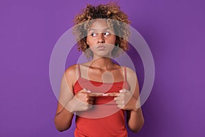 Young shy beauty African American woman connects fingers in front of chest