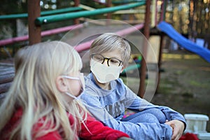 Young siblings in masks have fun