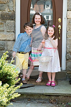 Young Siblings Outside Dressed Up for Easter holding Baskets