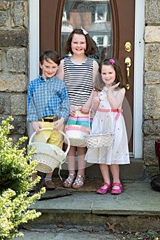 Young Siblings Outside Dressed Up for Easter holding Baskets