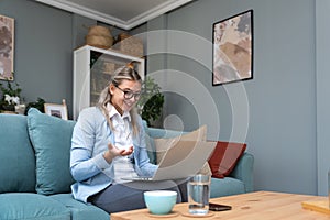 Young sick freelance business woman working at home, work on laptop computer. Online remote working, female wireless connection
