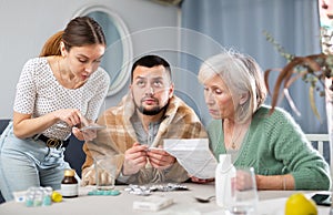 Young sick man choosing drugs with family