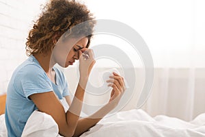 Young sick woman with flu blowing her nose