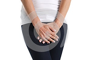 Young sick woman holds hands pressing to perineum to lower abdomen photo