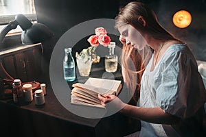 Young sick woman reading book at the hospital