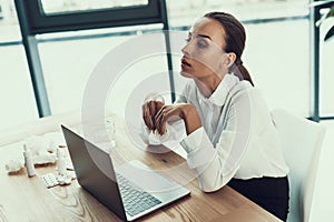 Young Sick Woman in White Shirt Sitting in Office.