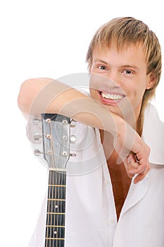 Young singer leans elbows on guitar and laughs