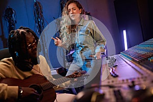 Young singer singing a song in the studio