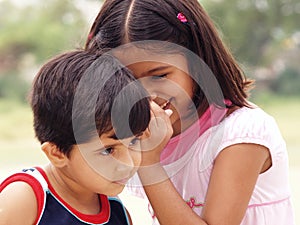 Young sisters sharing secrets