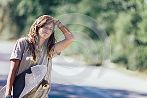 Young skateboard girl hitchhiking and stopping car at countryside road