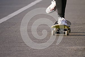 Young skateboarder legs riding skateboard