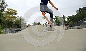 Young skateboarder practice ollie trick photo