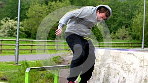 Young skateboarder skating the outdoor skatepark