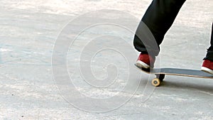 Young skateboarder skating the outdoor skatepark