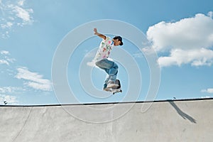A young skater boy fearlessly riding