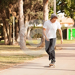 Young skater rolling down the street