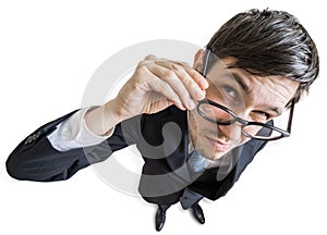 Young skeptic man with glasses is looking at you. View from above. Isolated on white background