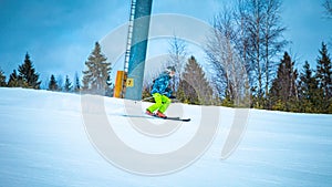 Young skier going quickly down the slope