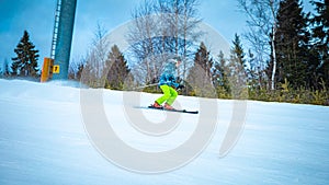Young skier going quickly down the slope