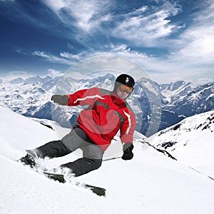 Young skier in high mountains