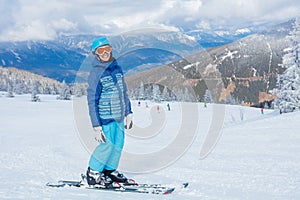 Young skier in winter resort