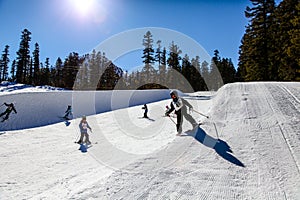 Young kids Ski/Snowboard the mini half-pipe at Mammoth Mountain, California USA