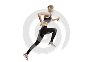 Young slender girl in a sports uniform with dumbbells in her hands runs. Sport and health. Isolated on a white background