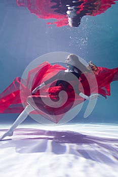 Young Slender Girl Underwater with a Cloth. Water Magic. Underwater Photography. Art
