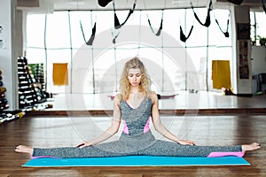 Young slim blond woman in yoga class