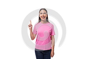 young slim caucasian brunette woman in a pink t-shirt on a white background with copy space