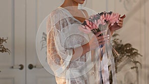 Young Slim Girl in Lingerie Holds Flowers in The Hands