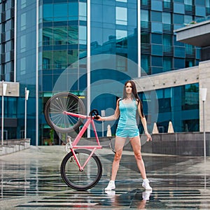 Young slim sportive woman on bicycle