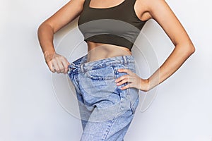 A young slim woman demonstrates successful weight loss