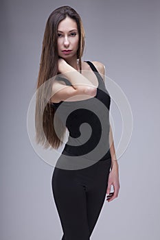 Young slim woman in fashionable dress on white bac