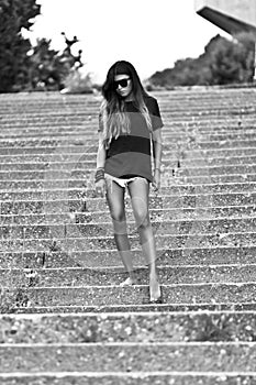 Young slim woman in shorts and a shirt