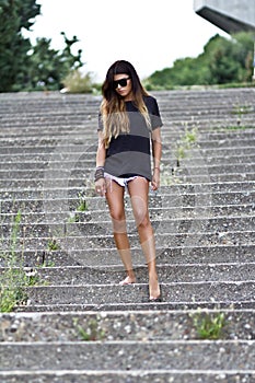 Young slim woman in shorts and a shirt