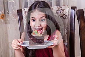 Young small beautiful middle eastern child girl with chocolate cake with pineapple, strawberry, and milk with red dress and dark