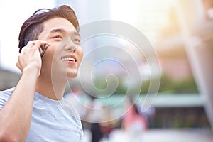 Young smart asian male teen calling phone call