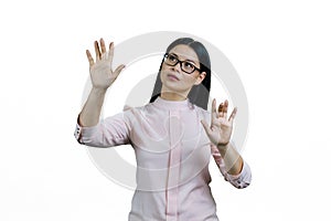 Young smart asian woman is touching invisible virtual screen with both hands.