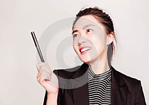 Young smart beautiful asian business woman wore black suit and glasses,smart and thinking holding Document, talking phone