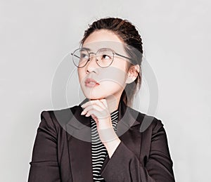 Young smart beautiful asian business woman wore black suit and glasses,smart and thinking holding Document, talking phone