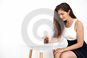 Young and smart beautiful Caucasian woman protecting and taking care of miniature house