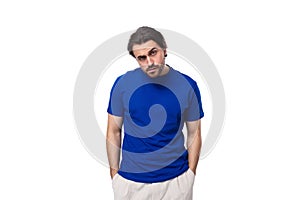 young smart brunette man with a beard dressed in a blue t-shirt is brainstorming on a white background