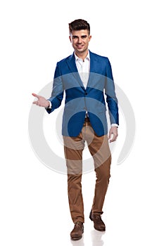 Young smart casual man welcoming