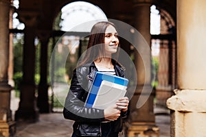 Young smart female college student on campus outdoors